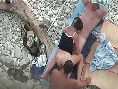 Couple fucks on the beach as a dude witnesses